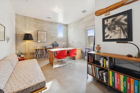 a living room with furniture and book shelf