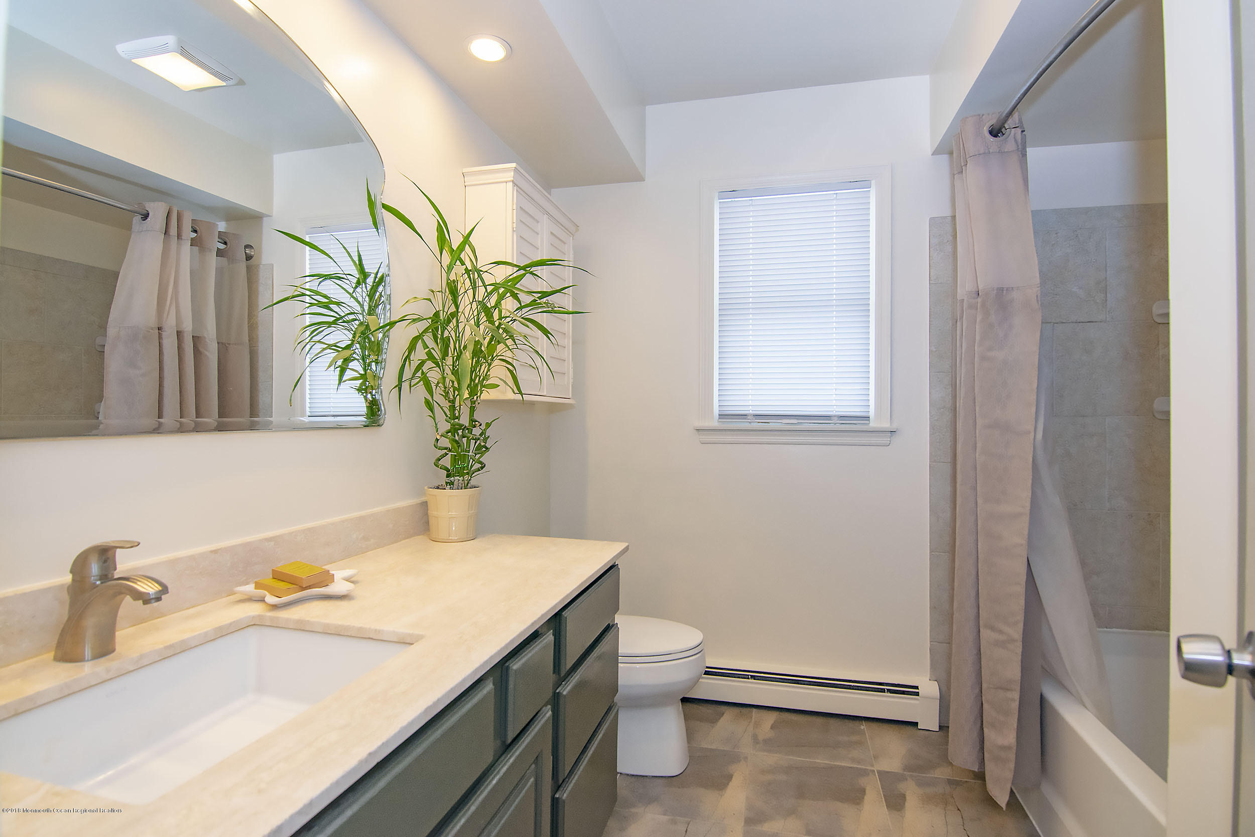 43 Compass Road Waretown, NJ 08758 - Photo 12 of 27 a bathroom with a sink a toilet and a mirror