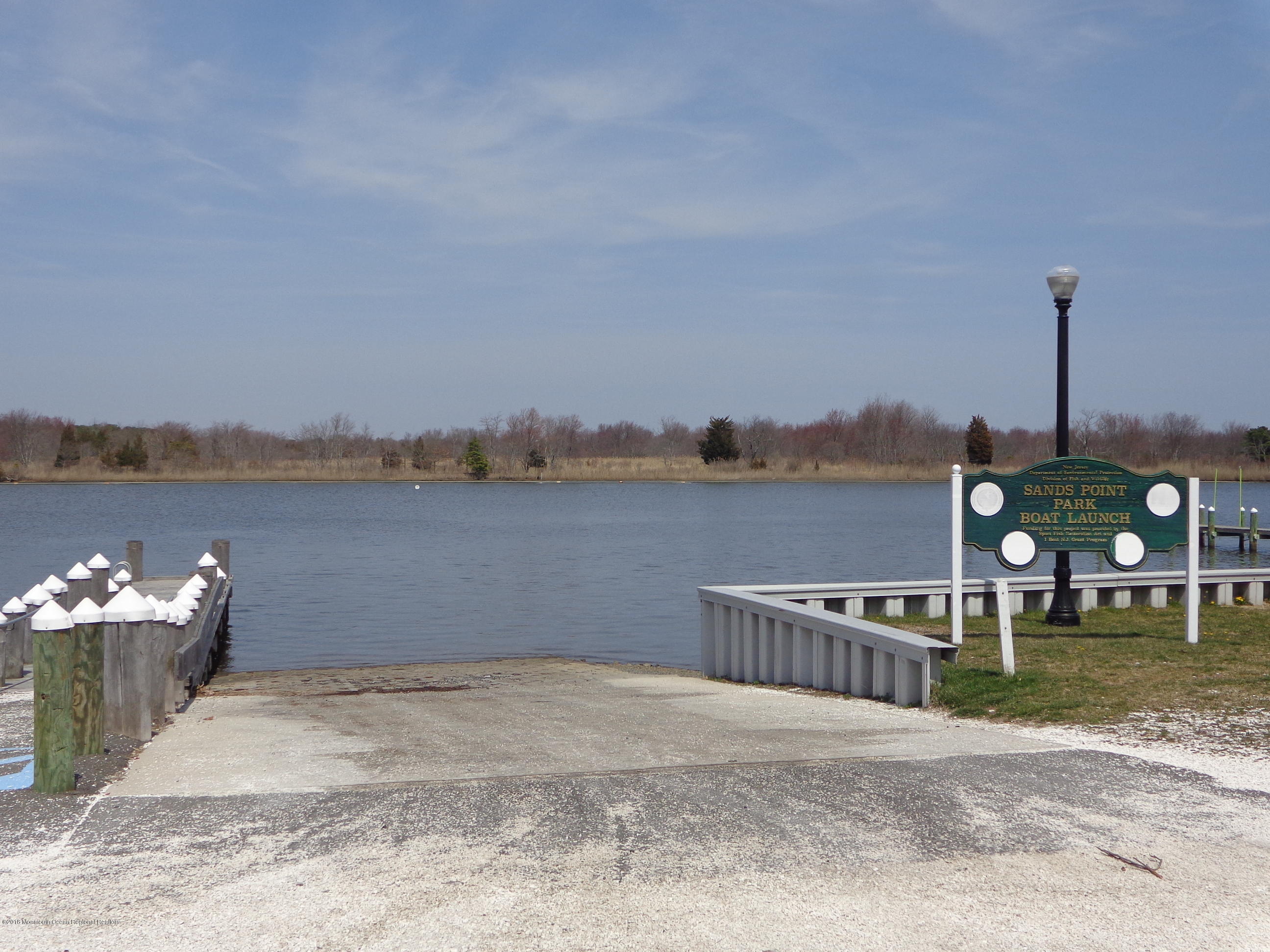 43 Compass Road Waretown, NJ 08758 - Photo 23 of 27 a terrace with a bench and lake view