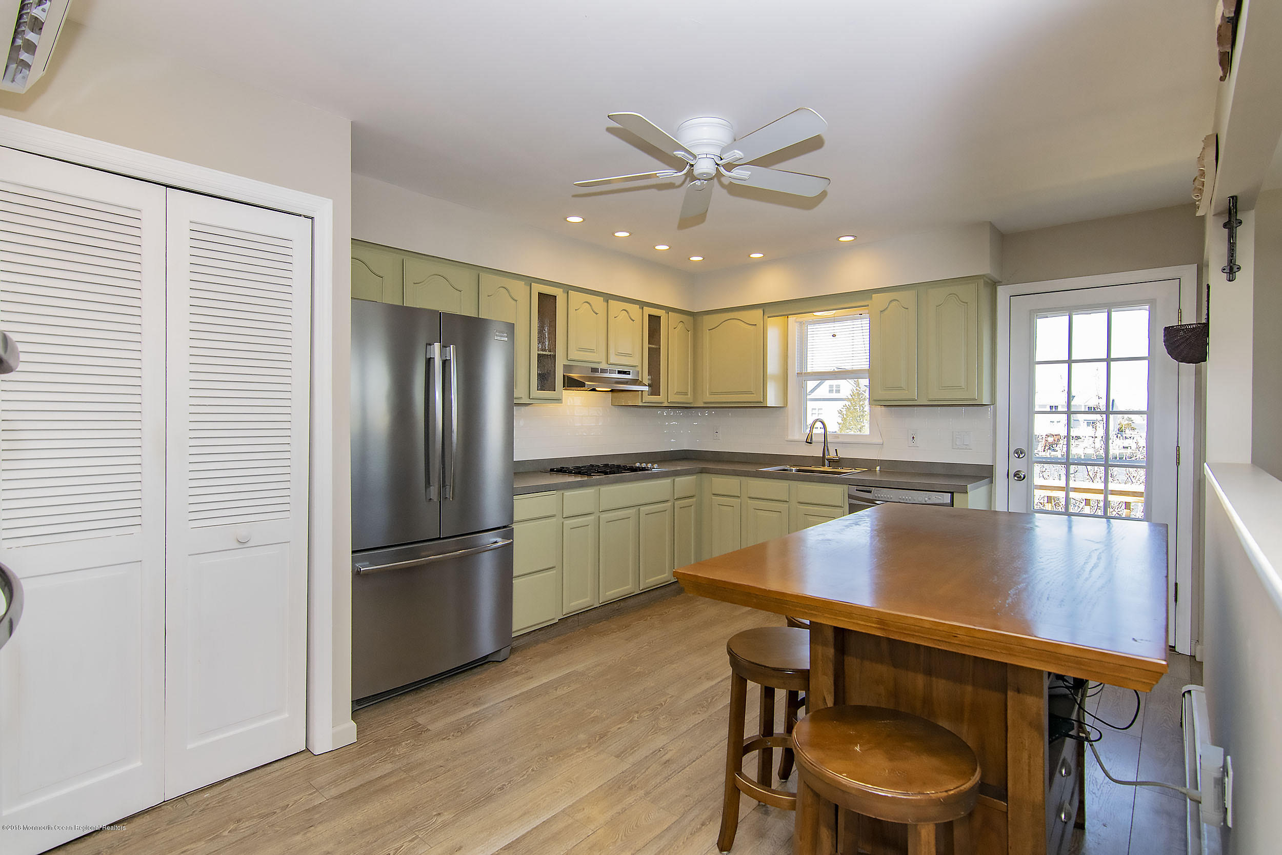 43 Compass Road Waretown, NJ 08758 - Photo 7 of 27 a kitchen with a refrigerator a sink and cabinets