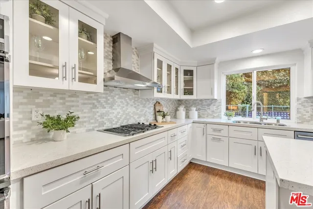 a white kitchen with sink and window