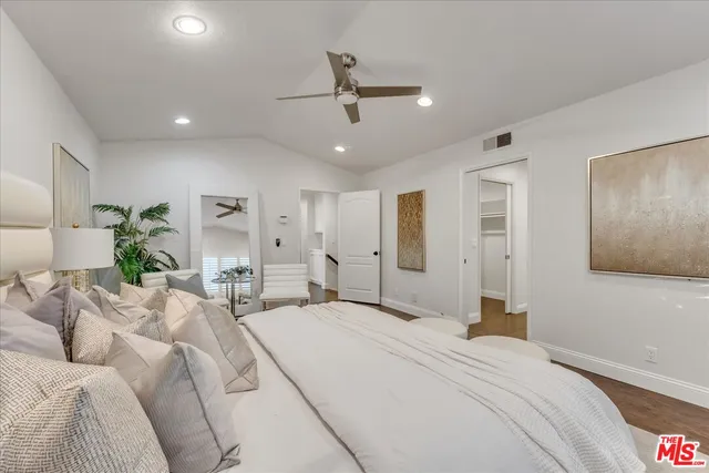 a bedroom with a bed a couch and a window