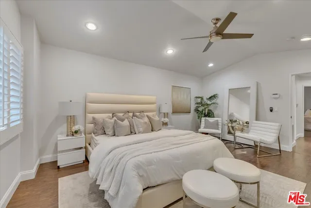 a view of a hallway with wooden floor and closet