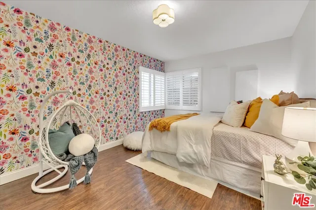 a bedroom with a bed and a large mirror