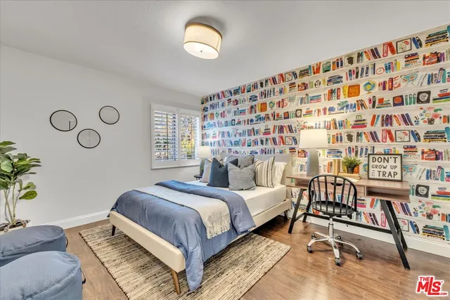 a view of a swimming pool with chairs and wooden fence