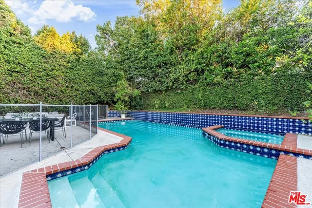 a view of a house with a yard patio and swimming pool