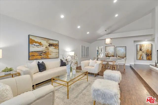 a living room with furniture and a painting