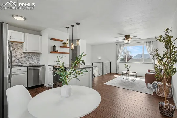 a dining room with furniture and wooden floor