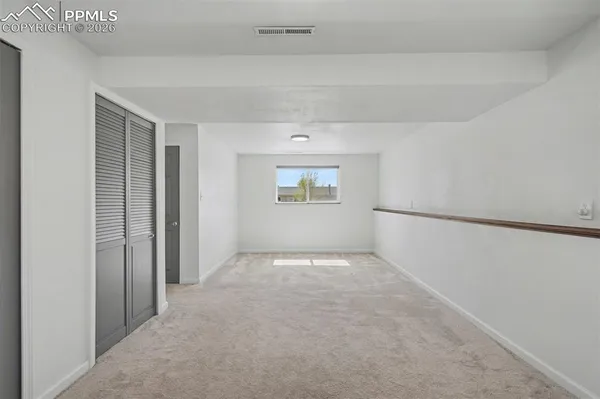 a view of an empty room with a window