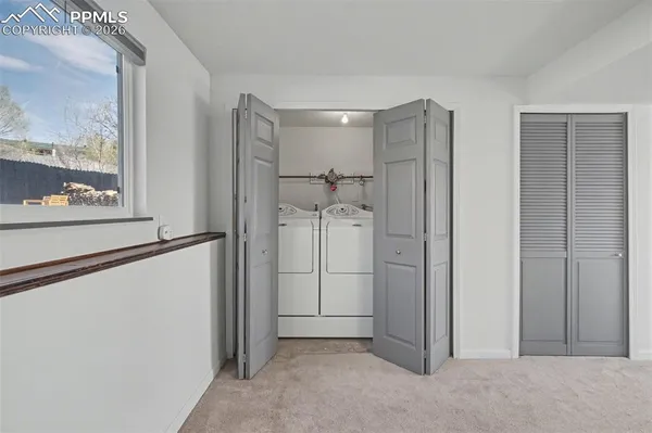 a view of a hallway with wooden shelves