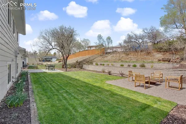 a view of a garden with lawn chairs