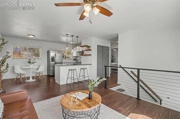 a living room with furniture and a dining table