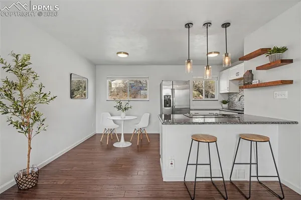 a kitchen with granite countertop white cabinets and counter space