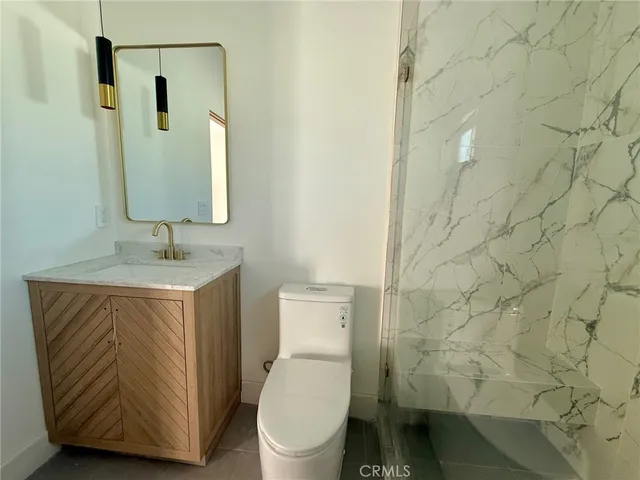 a white toilet sitting next to a bathroom sink