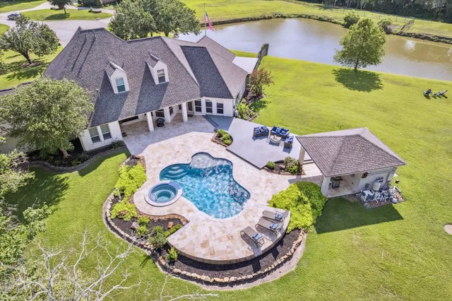 a view of a house with swimming pool and porch