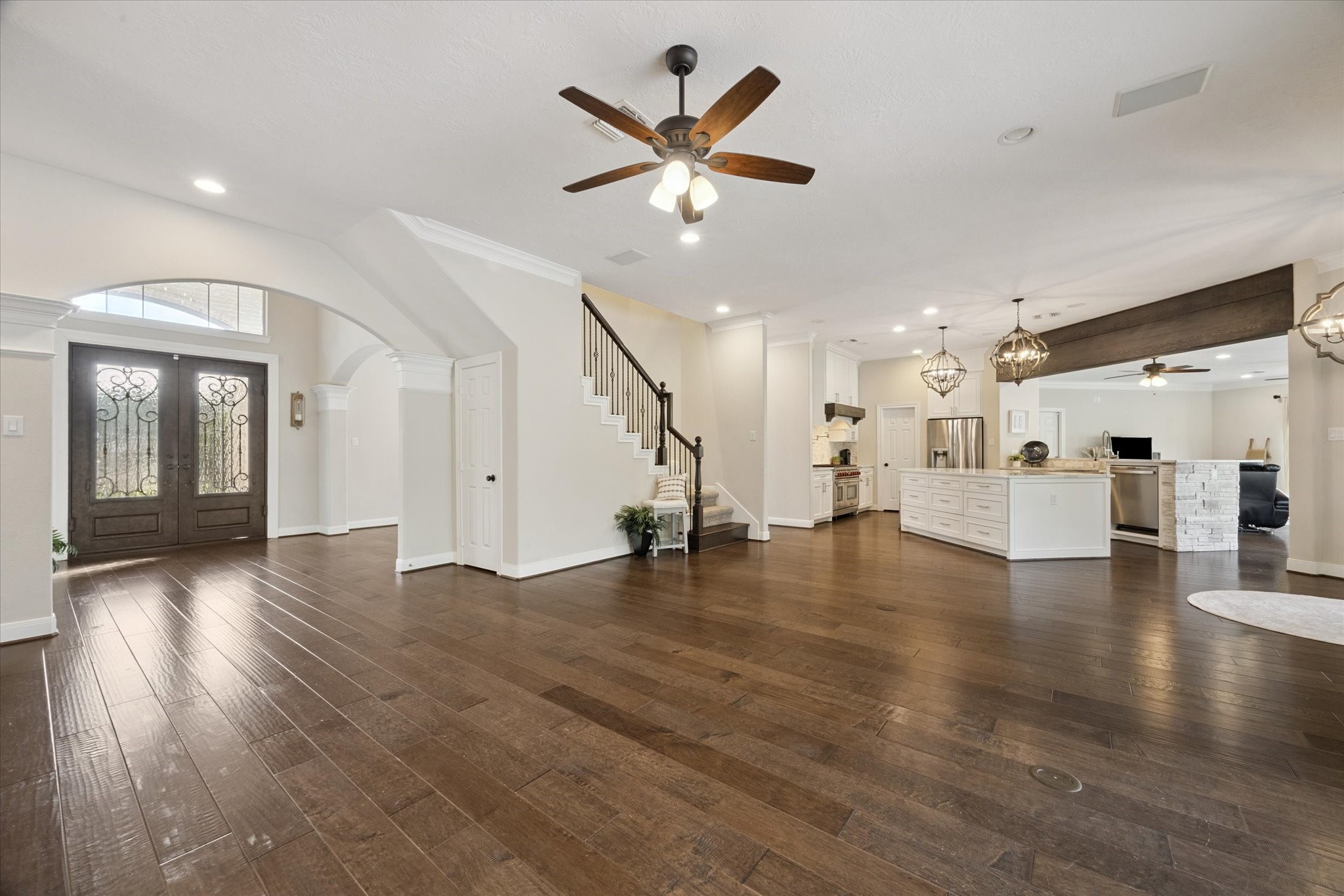 2904 Bridle Path Lane Friendswood, TX 77546 - Photo 11 of 49 a view of an empty room with wooden floor and a ceiling fan