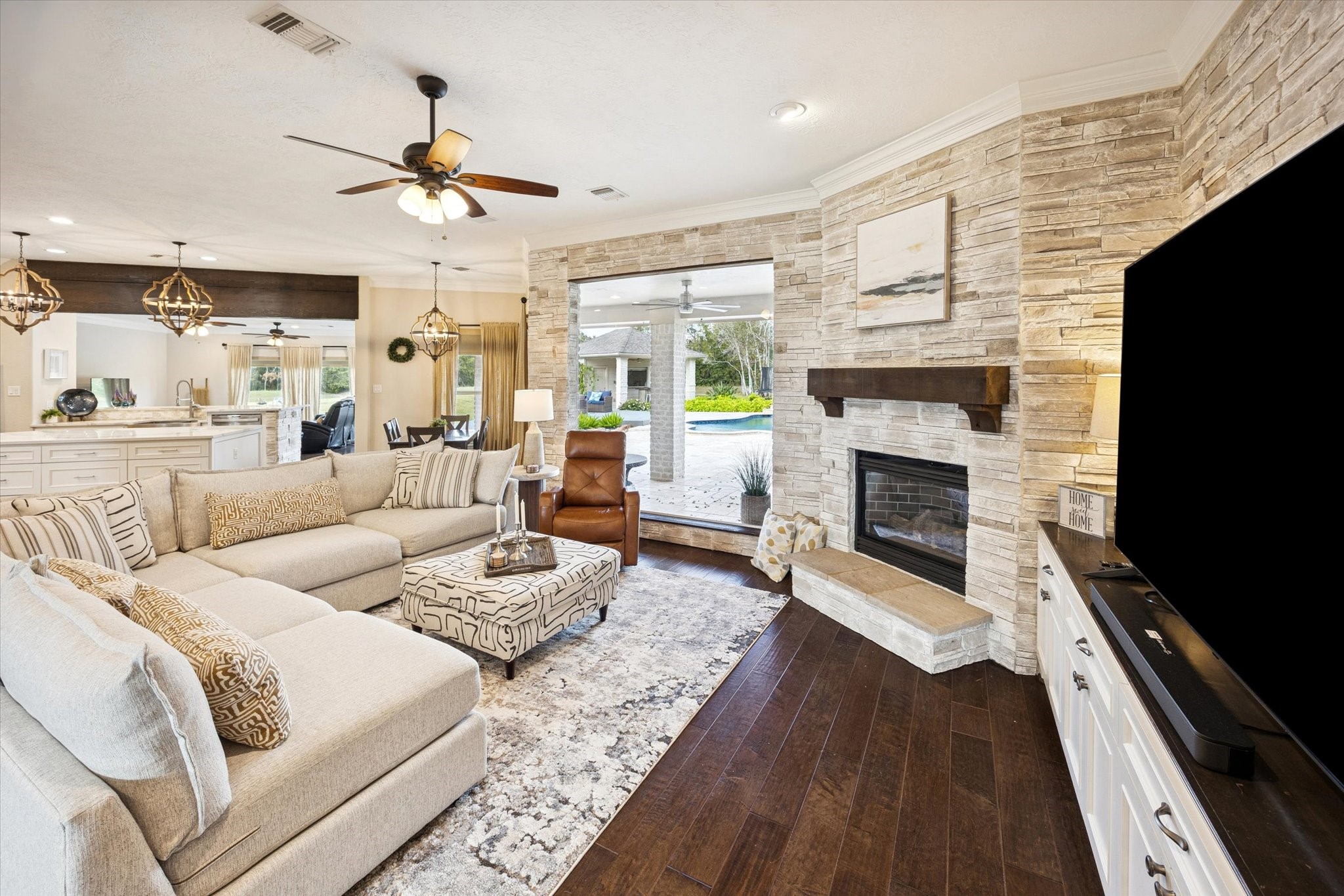 2904 Bridle Path Lane Friendswood, TX 77546 - Photo 12 of 49 a living room with furniture fireplace and a flat screen tv
