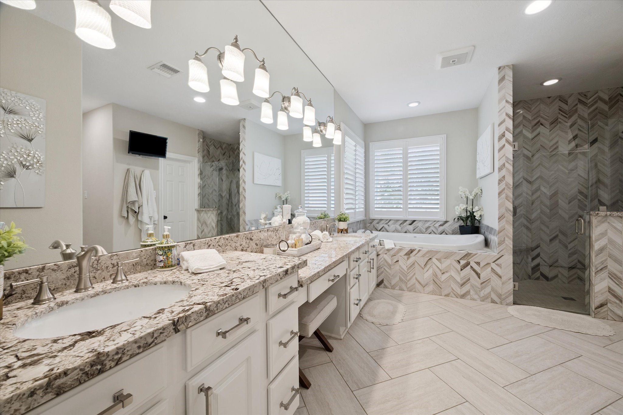 2904 Bridle Path Lane Friendswood, TX 77546 - Photo 25 of 49 a spacious bathroom with a granite countertop sink a large mirror and a shower