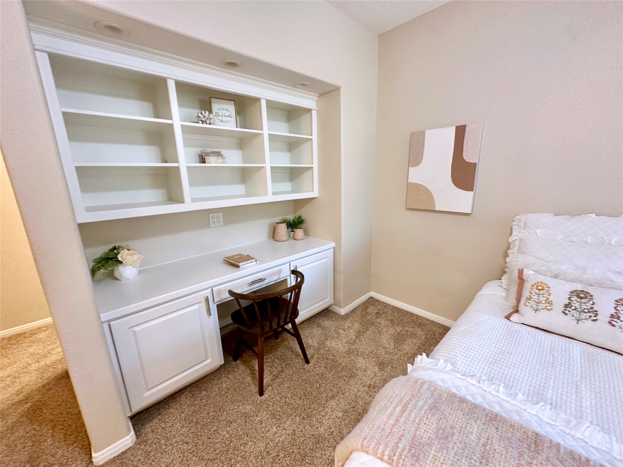 2904 Bridle Path Lane Friendswood, TX 77546 - Photo 33 of 49 The room also includes a built-in desk perfect for work or study, along with a charming window seat that doubles as additional storage—ideal for reading or relaxing.