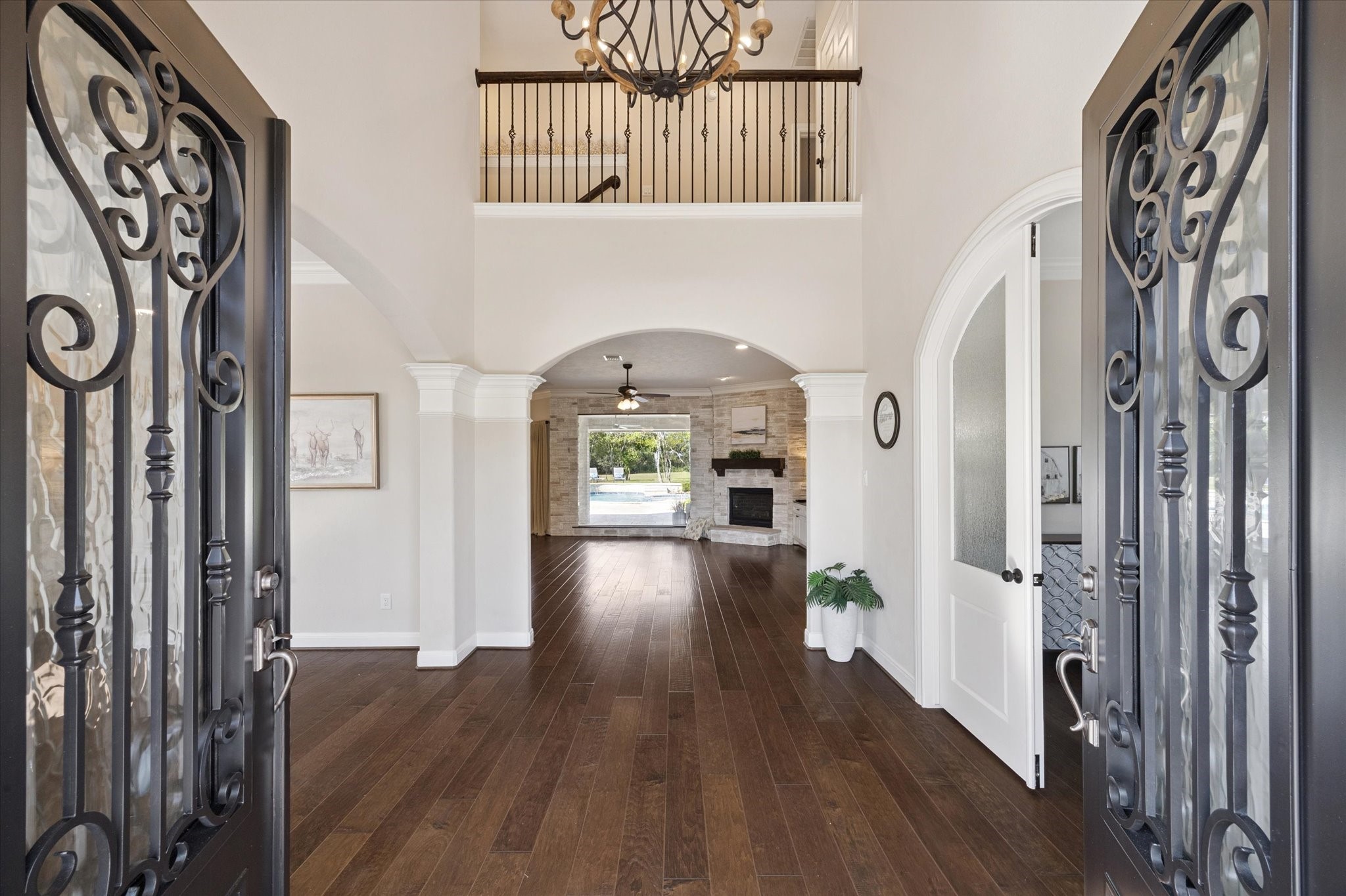 2904 Bridle Path Lane Friendswood, TX 77546 - Photo 5 of 49 The two-story foyer with elegant arched walls welcomes you into a light-filled home, featuring rich hand-scraped wood floors and high-end finishes throughout.