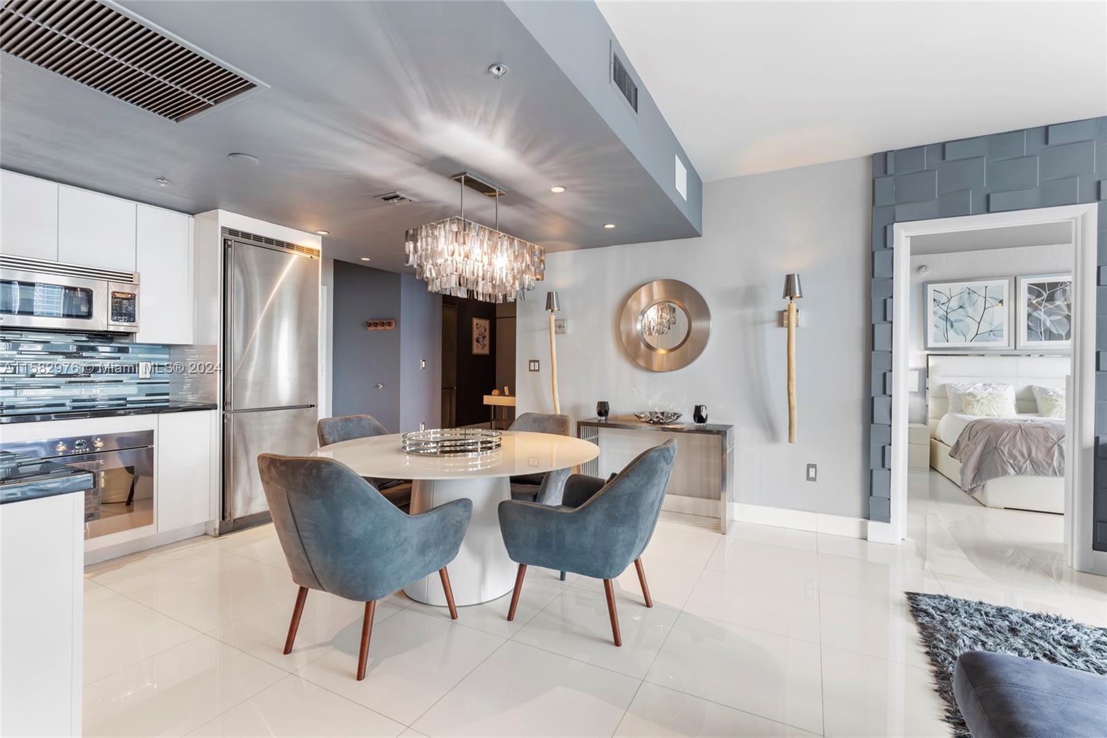 92 Southwest 3rd Street, Unit 2303 Miami, FL 33130 - Photo 11 of 35 a view of a dining room and kitchen with furniture a rug and wooden floor
