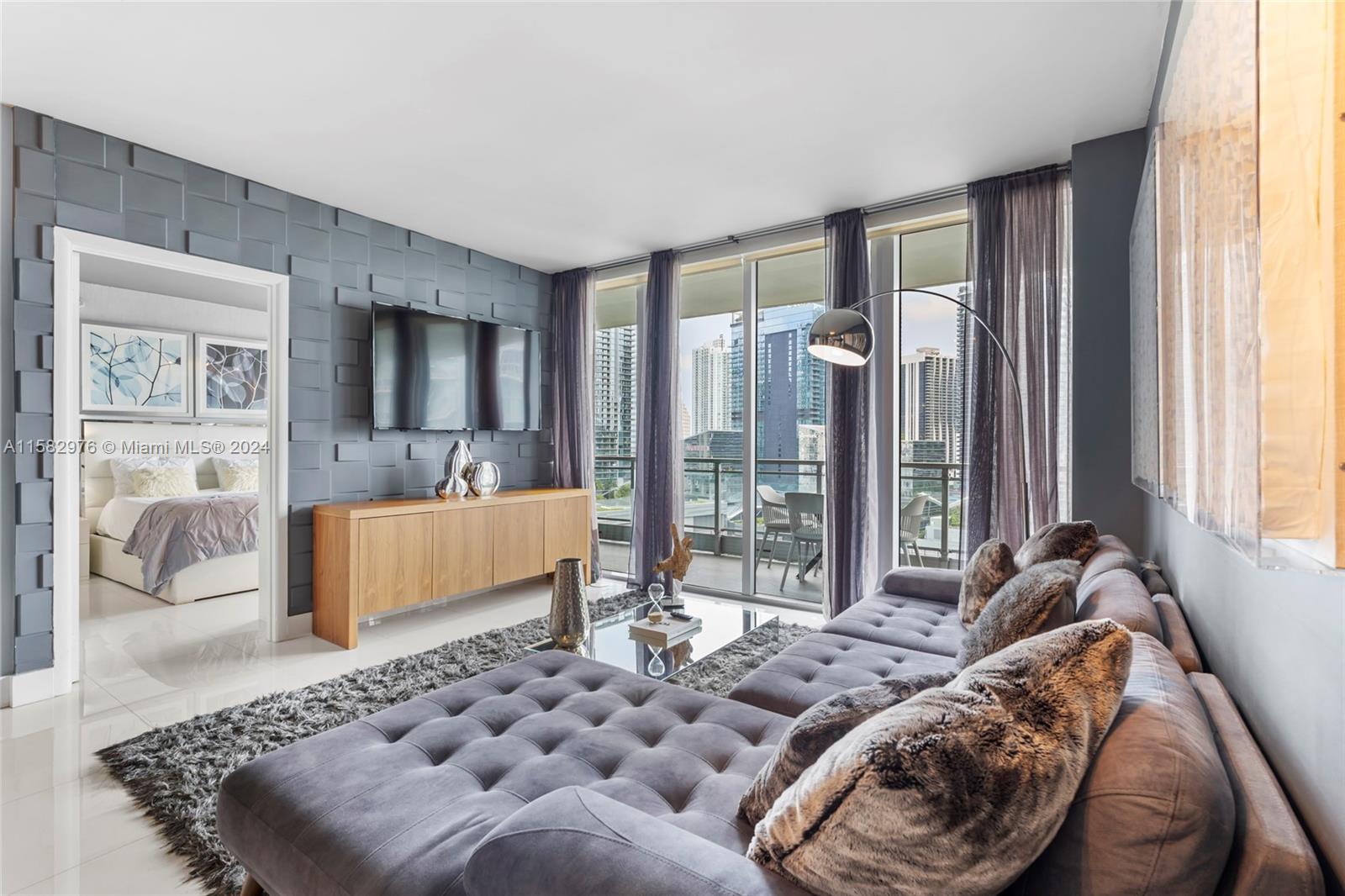 92 Southwest 3rd Street, Unit 2303 Miami, FL 33130 - Photo 12 of 35 a bedroom with furniture and a large window