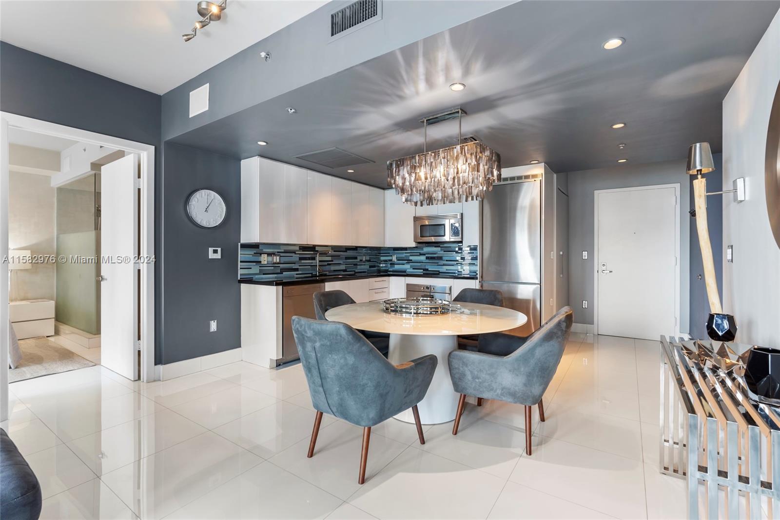 92 Southwest 3rd Street, Unit 2303 Miami, FL 33130 - Photo 13 of 35 a large kitchen with a table and chairs