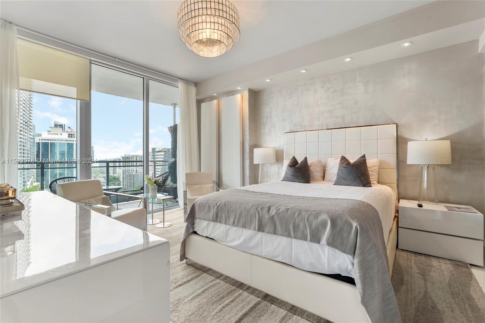 92 Southwest 3rd Street, Unit 2303 Miami, FL 33130 - Photo 18 of 35 a spacious bedroom with a bed and a large window