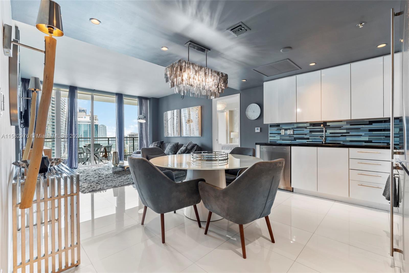 92 Southwest 3rd Street, Unit 2303 Miami, FL 33130 - Photo 2 of 35 a large kitchen with a table and chairs