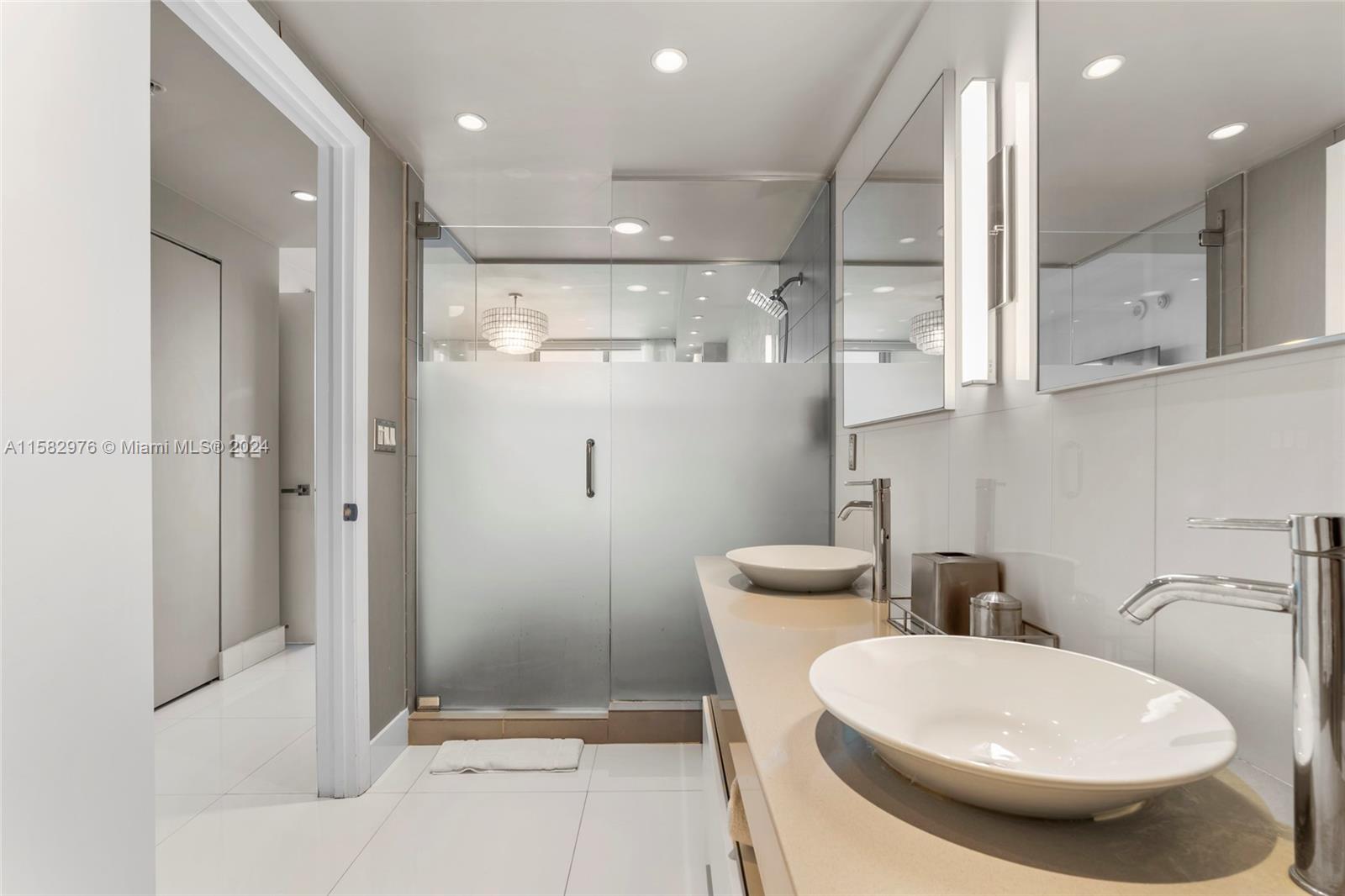 92 Southwest 3rd Street, Unit 2303 Miami, FL 33130 - Photo 22 of 35 a bathroom with a toilet sink and shower