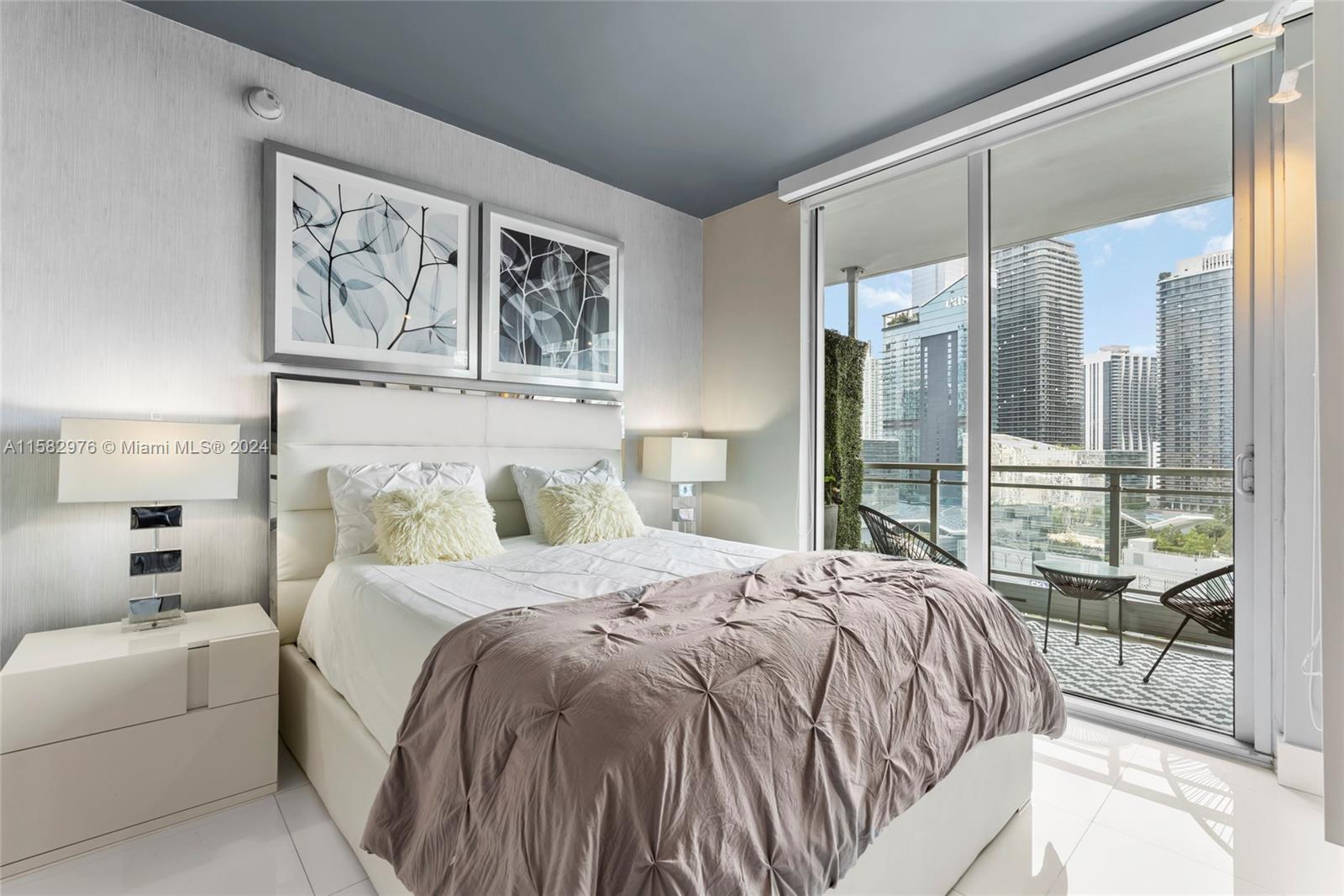 92 Southwest 3rd Street, Unit 2303 Miami, FL 33130 - Photo 23 of 35 a bedroom with a large bed and a painting on the wall