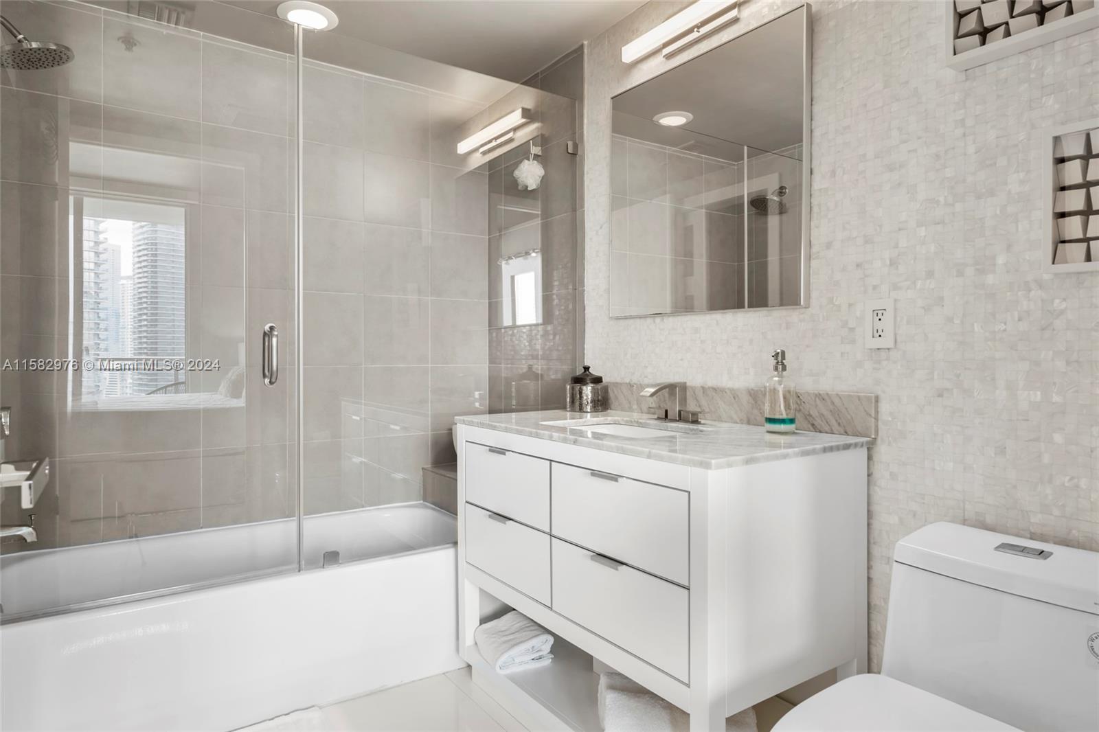 92 Southwest 3rd Street, Unit 2303 Miami, FL 33130 - Photo 24 of 35 a bathroom with a sink toilet vanity and bathtub