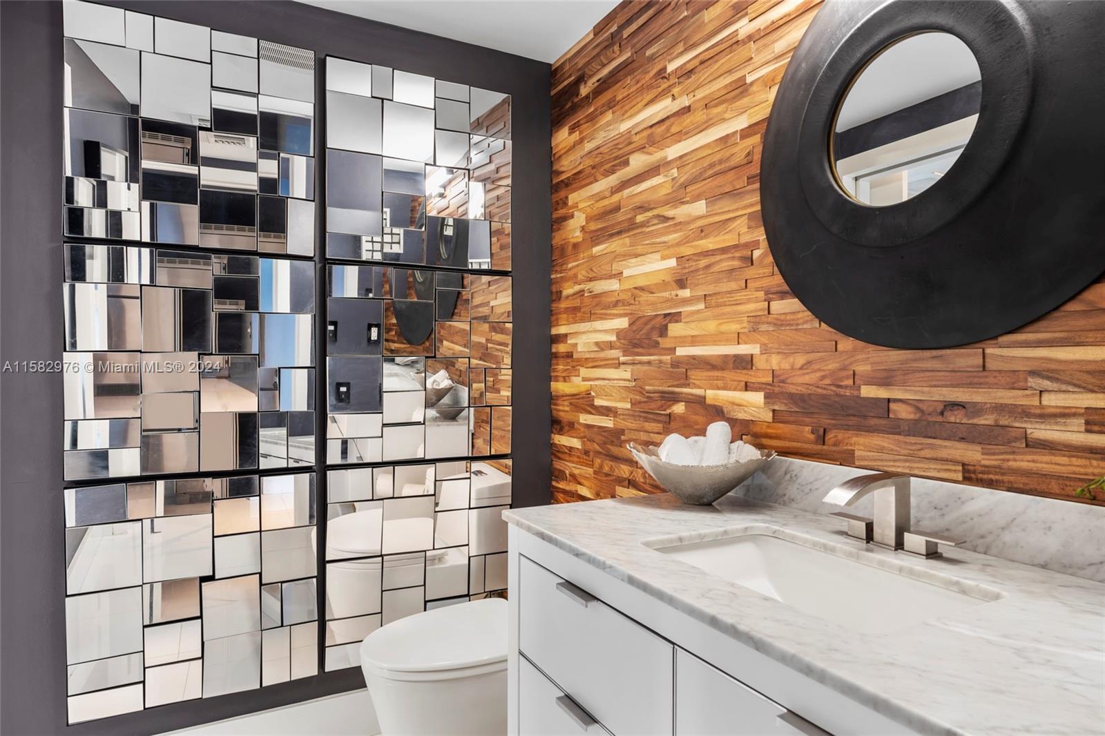 92 Southwest 3rd Street, Unit 2303 Miami, FL 33130 - Photo 26 of 35 a bathroom with a sink and mirror