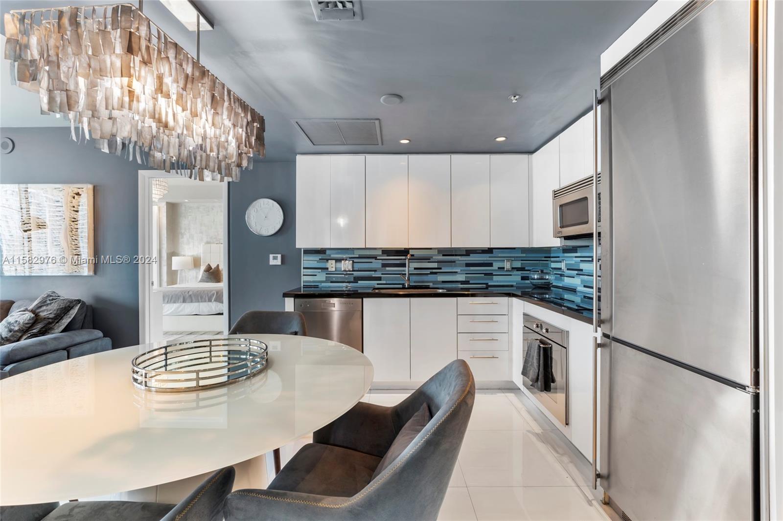 92 Southwest 3rd Street, Unit 2303 Miami, FL 33130 - Photo 3 of 35 a kitchen with refrigerator and stove