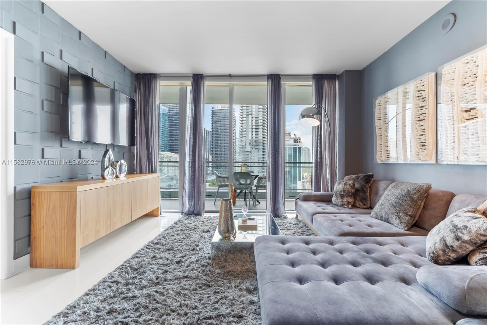 92 Southwest 3rd Street, Unit 2303 Miami, FL 33130 - Photo 10 of 35 a living room with furniture and a large window