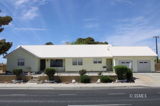 1043 South Downs Street Ridgecrest, CA 93555 - Photo 2 of 13 a front view of a house with a yard