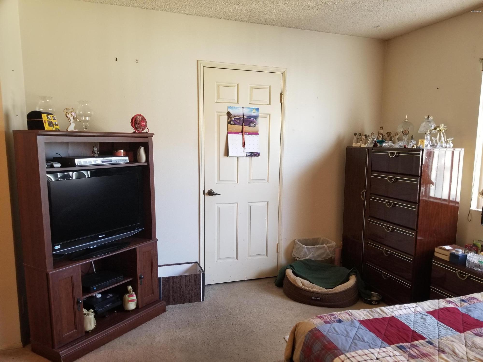 2047 East Bard Road Oxnard, CA 93033 - Photo 11 of 25 a living room with furniture and a flat screen tv