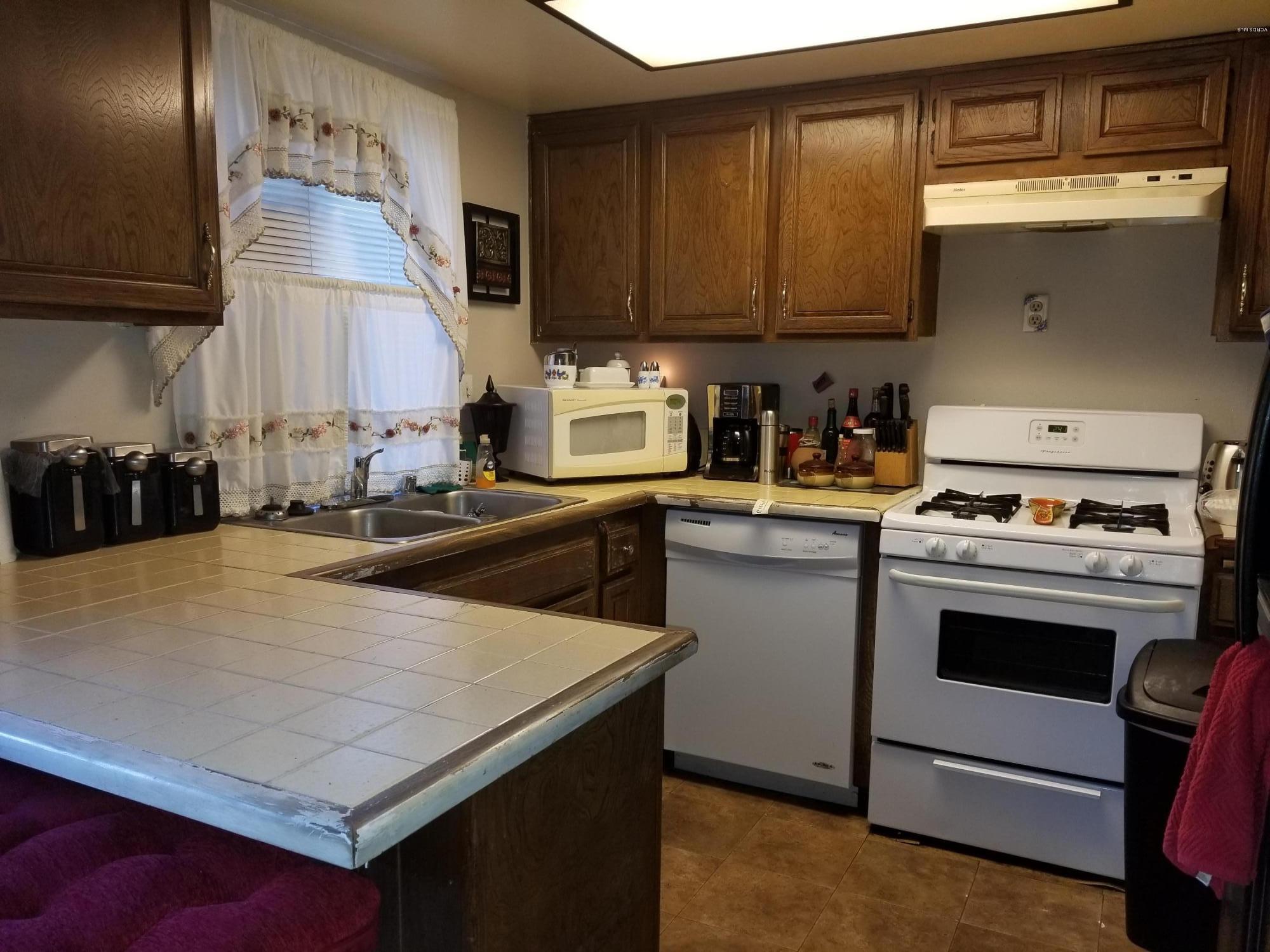 2047 East Bard Road Oxnard, CA 93033 - Photo 7 of 25 a kitchen with a stove and a refrigerator