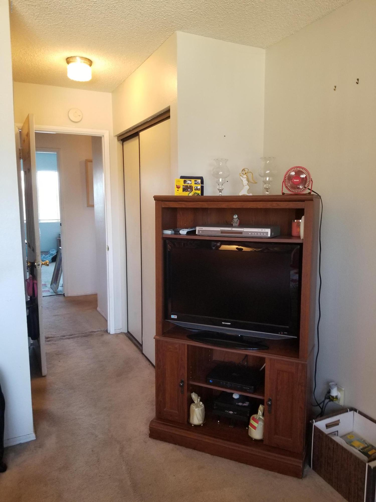 2047 East Bard Road Oxnard, CA 93033 - Photo 10 of 25 a living room with a flat screen tv and a lamp
