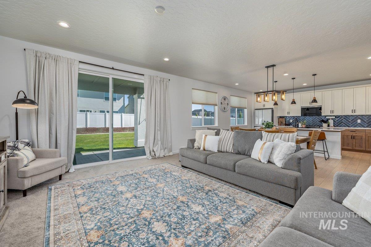 1380 West Chilitna Street Meridian, ID 83642 - Photo 22 of 50 Open-concept living space featuring a living room, dining area, and kitchen