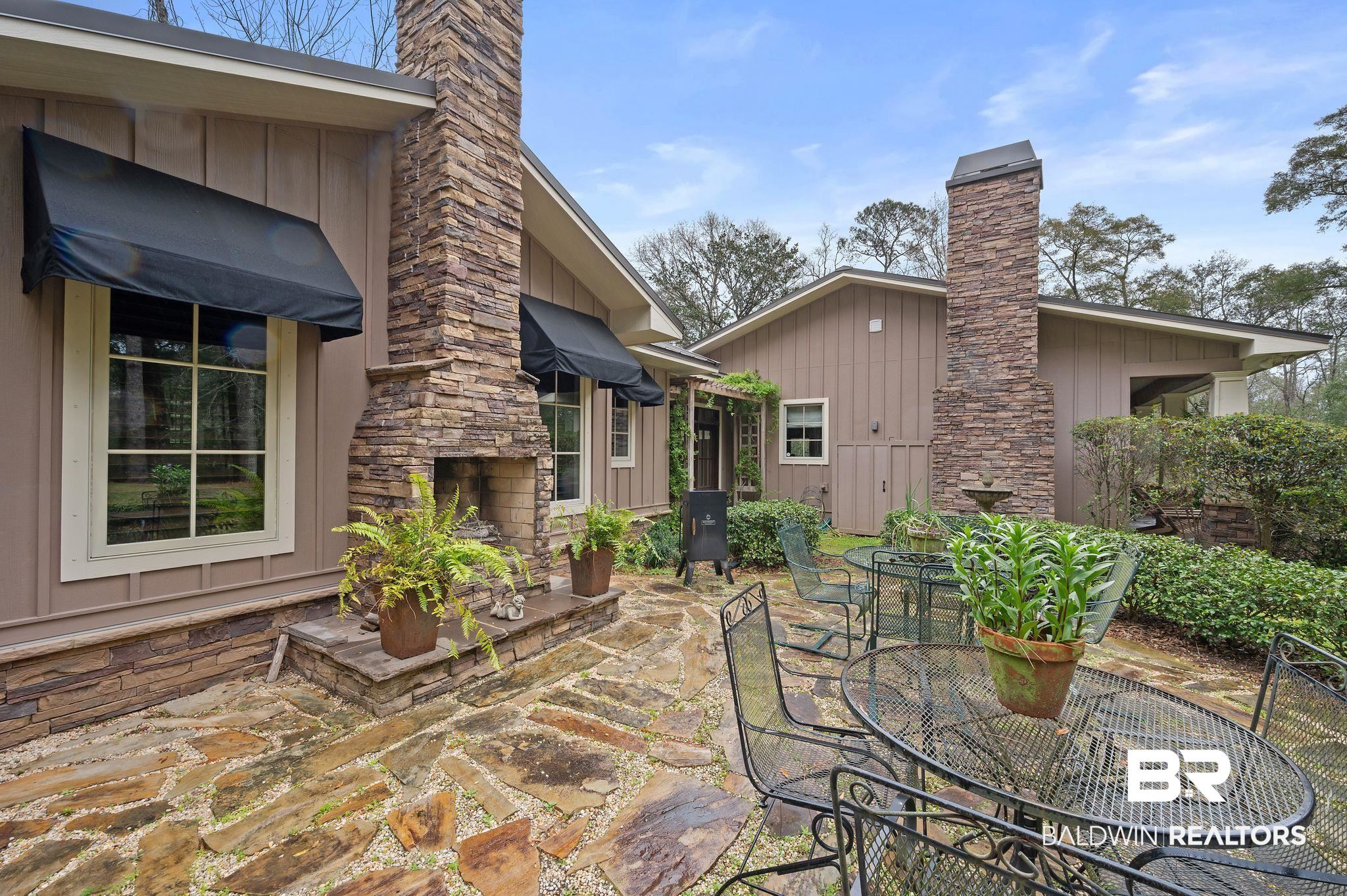 7850 Yorkhaven Road Mobile, AL 36695 - Photo 5 of 57 View of patio featuring outdoor dining area and a fireplace