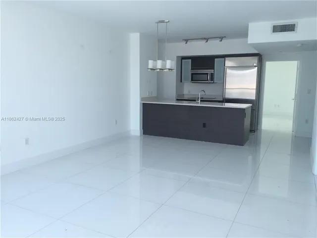 a large bathroom with a sink a mirror and a bathtub