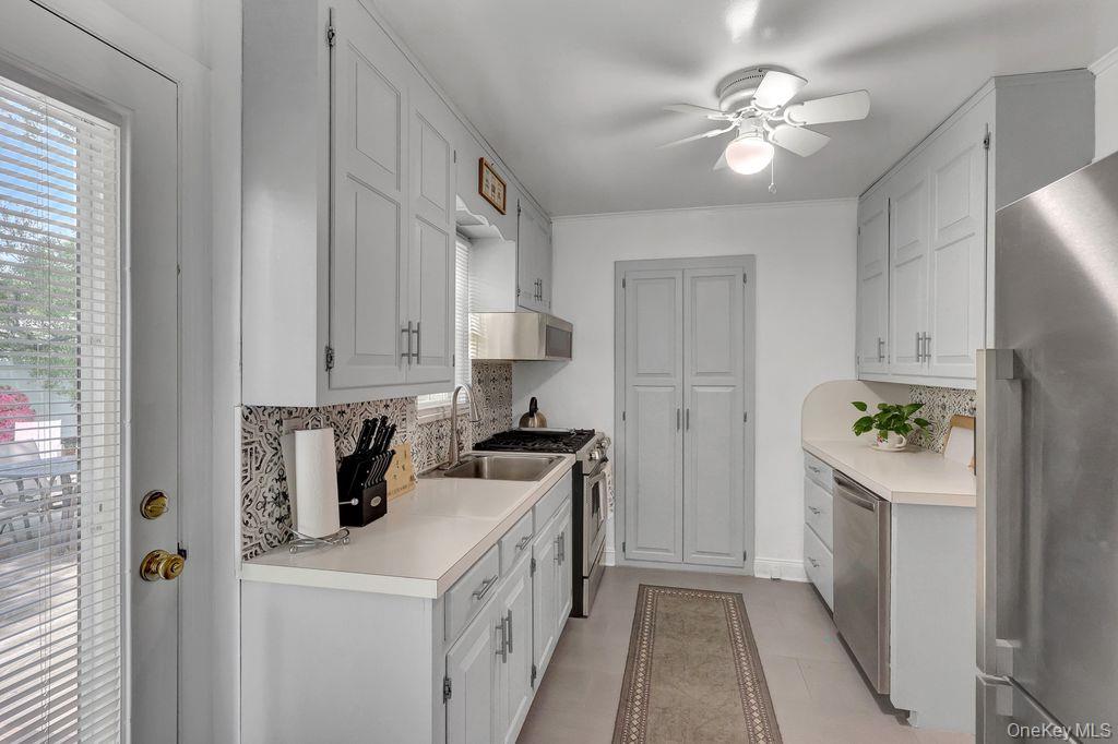5 Newell Road Merrick, NY 11566 - Photo 8 of 19 a kitchen with a stove a refrigerator and a cabinets
