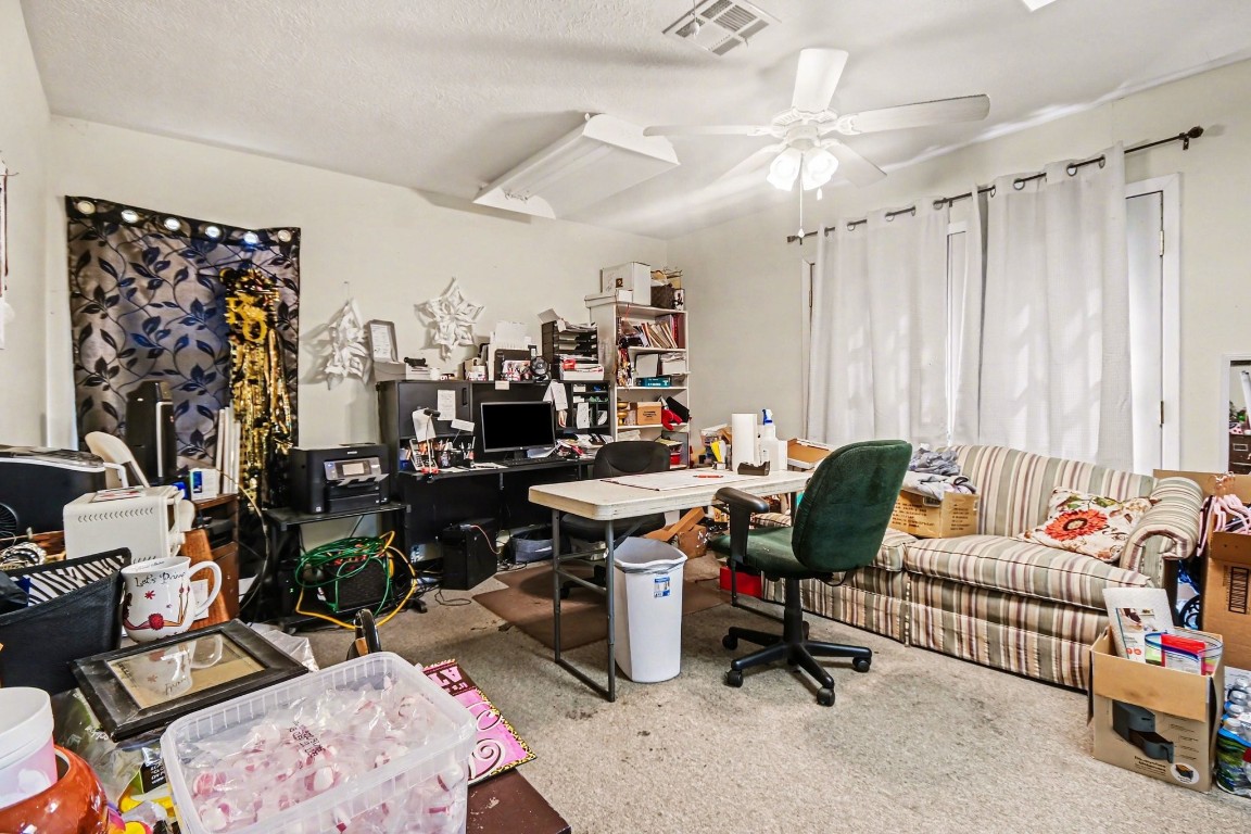 810 Miller Street Anahuac, TX 77514 - Photo 15 of 28 a view of a workspace with furniture and a couch