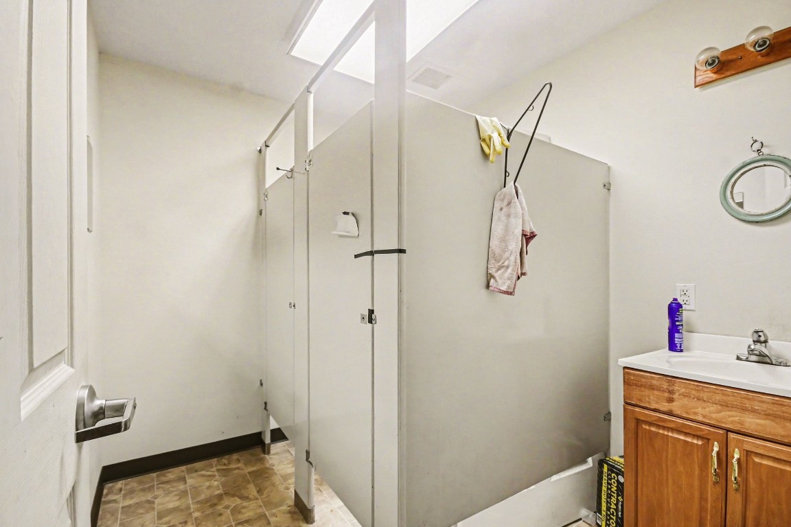 810 Miller Street Anahuac, TX 77514 - Photo 19 of 28 a bathroom with a shower and a sink