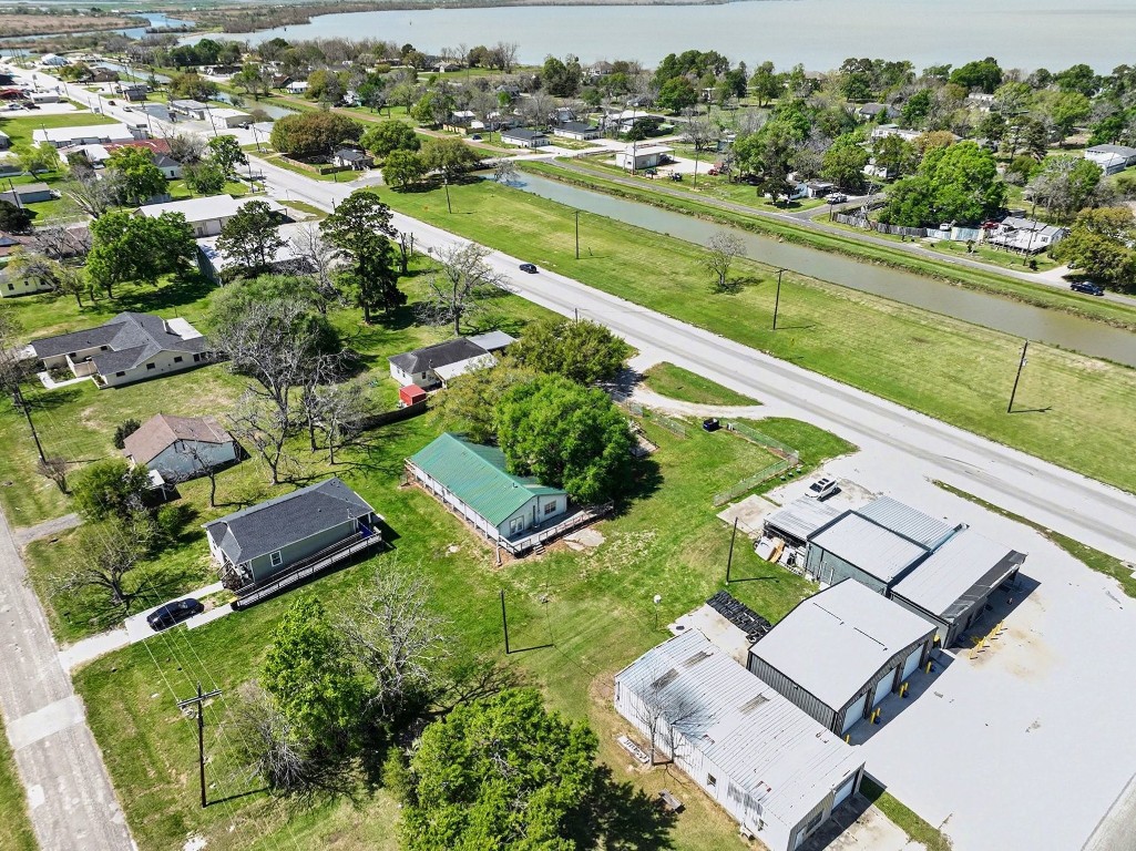 810 Miller Street Anahuac, TX 77514 - Photo 22 of 28 an aerial view of a house with a garden and lake view