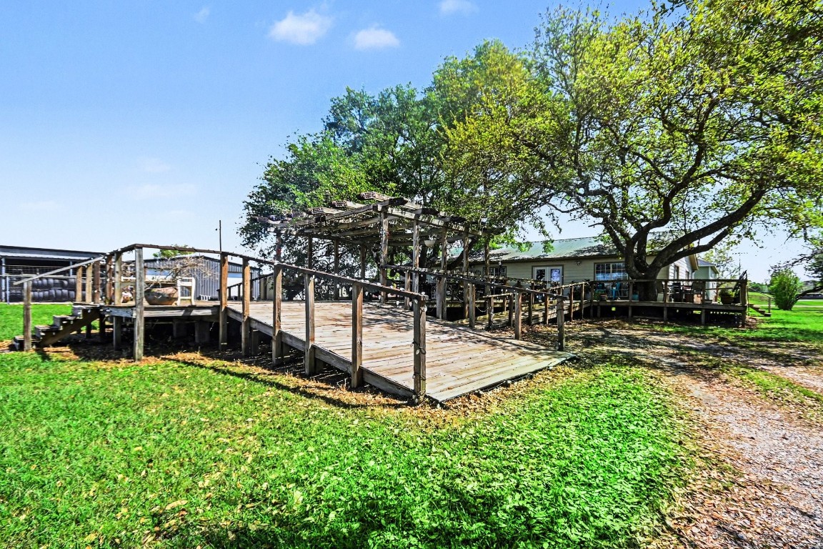 810 Miller Street Anahuac, TX 77514 - Photo 6 of 28 a view of a garden with a bench