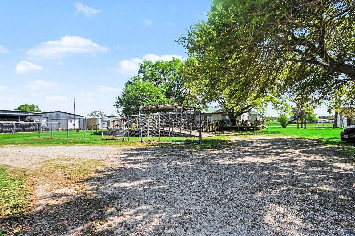 810 Miller Street Anahuac, TX 77514 - Photo 7 of 28 a view of a park with swings and slides
