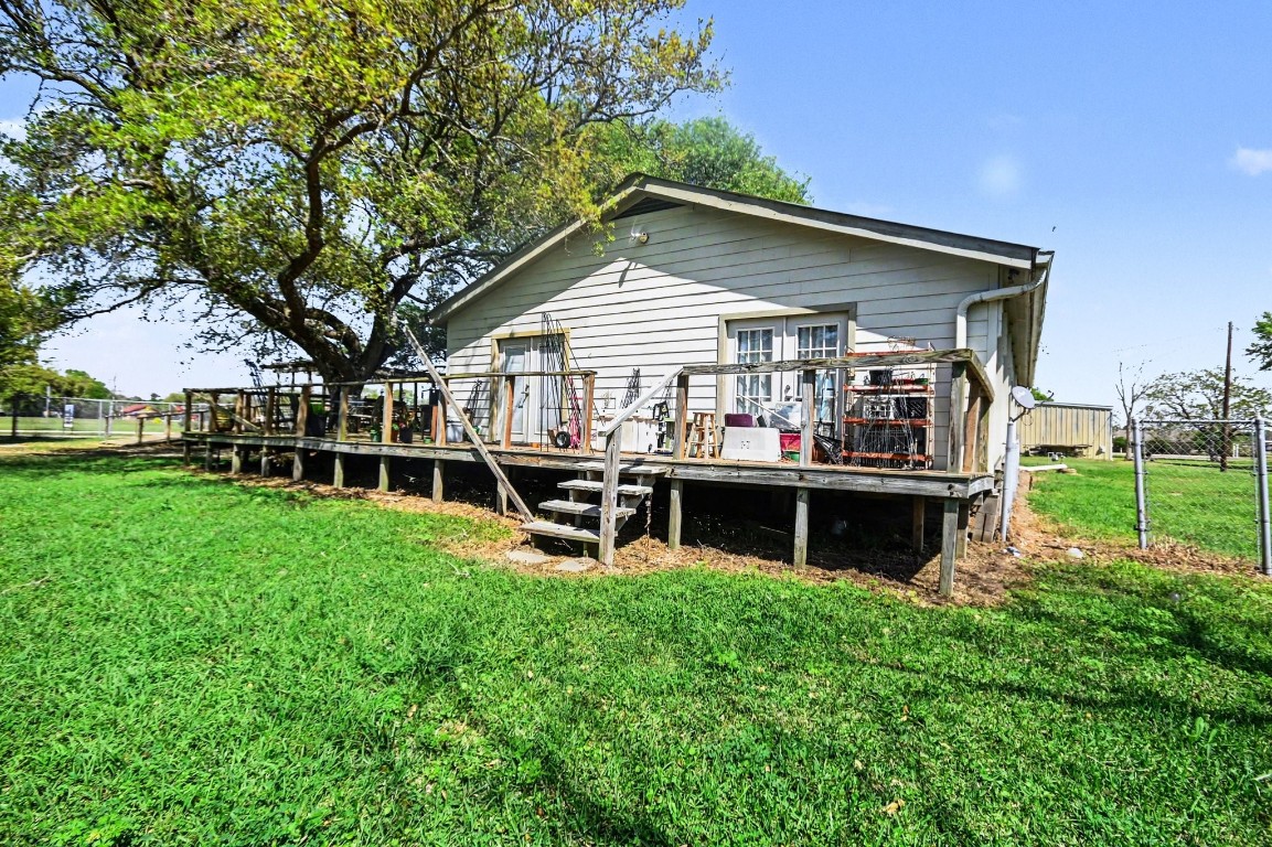 810 Miller Street Anahuac, TX 77514 - Photo 8 of 28 a front view of house with a garden and patio