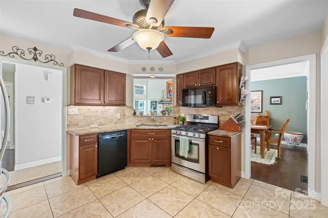 a kitchen with stainless steel appliances granite countertop a stove top oven a sink dishwasher a dining table and chairs with wooden floor